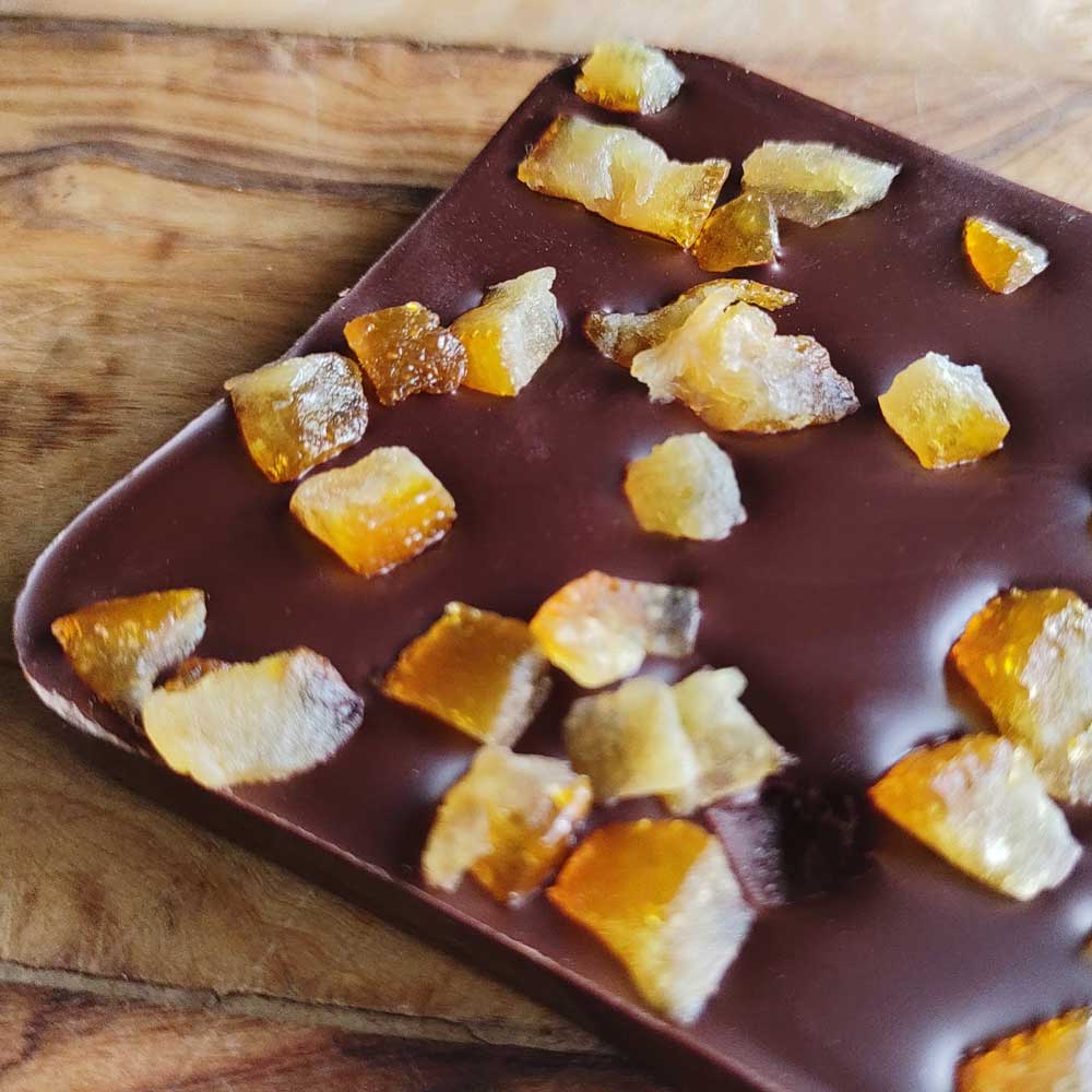 close up of Danieli dark chocolate orange bar on a wooden board