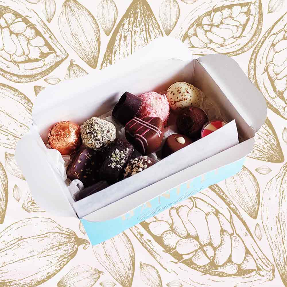 inside view of a Danieli chocolate gift box large ballotin on a cacao background