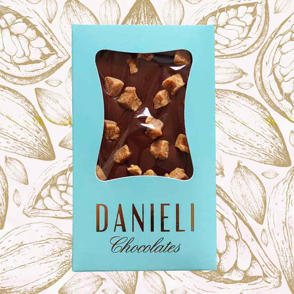 bar of danieli milk chocolate fudge bar on a cacao background