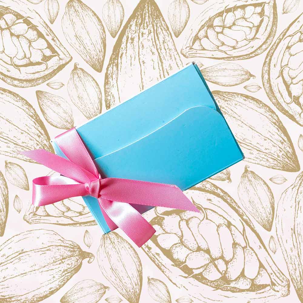 Top view of a mini ballotin of chocolates for Mothers Day with a pink ribbon
