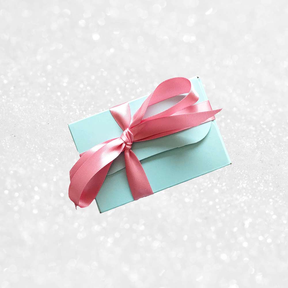 top view of a gift box of Danieli rose and violet chocolate creams on a snowy background