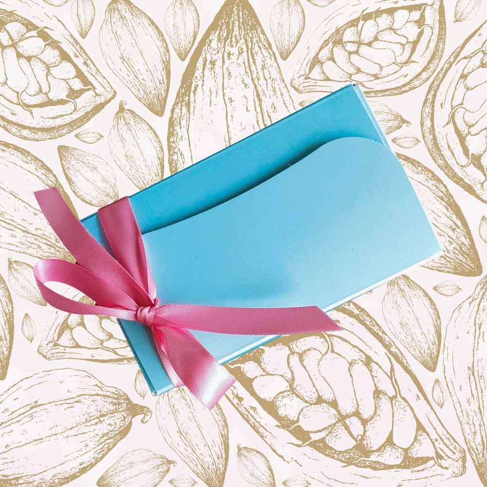 Top view of a small ballotin of chocolates for Mothers Day with a pink ribbon