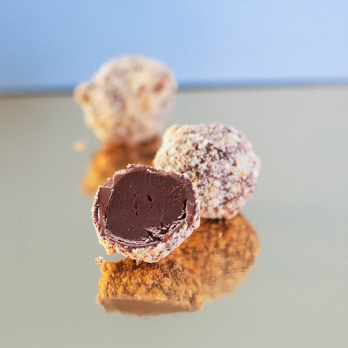 Biscuit milk chocolate truffle on a gold background