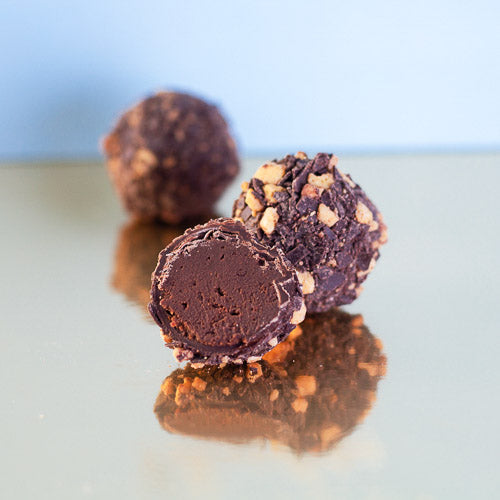 Dark chocolate caramel truffle on a gold background
