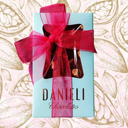 top view of gift pack of three danieli chocolate bars on a cacao background