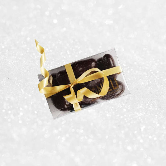 top view of a gift box of Danieli dark chocolate brazils on a snowy background