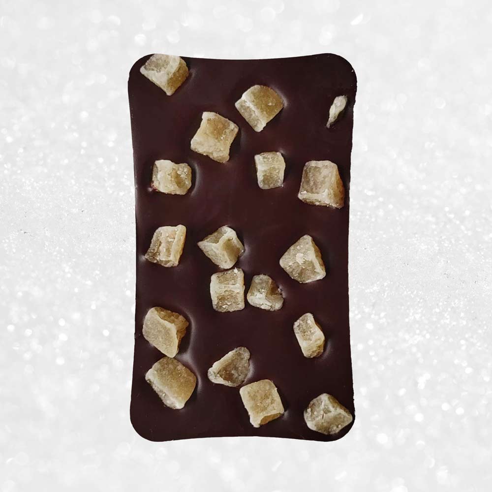 whole bar of Danieli dark chocolate ginger bar on a snowy background