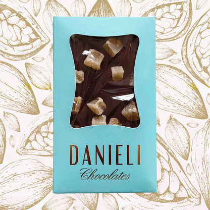 Danieli dark chocolate bar with ginger on a snowy background