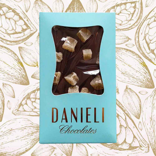 Danieli dark chocolate bar with ginger on a cacao pod background