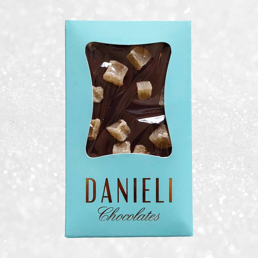 Danieli dark chocolate bar with ginger on a snowy background