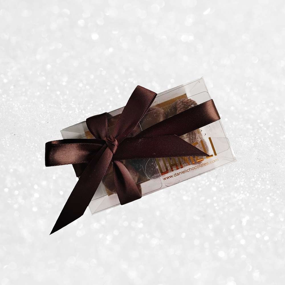 top view of a gift box of Danieli dark chocolate gingers on a snowy background