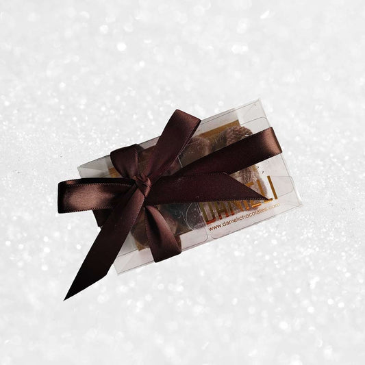 top view of a gift box of Danieli dark chocolate gingers on a snowy background