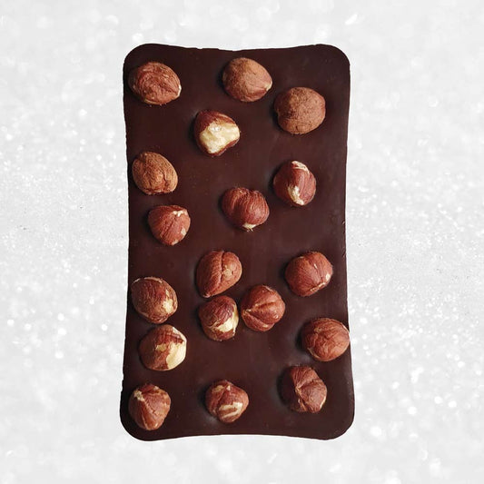 whole bar of Danieli dark chocolate hazelnut bar on a cacao background