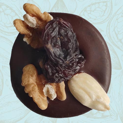 Danieli individual chocolates dark chocolate mendiant on a blue and brown cacao pod background
