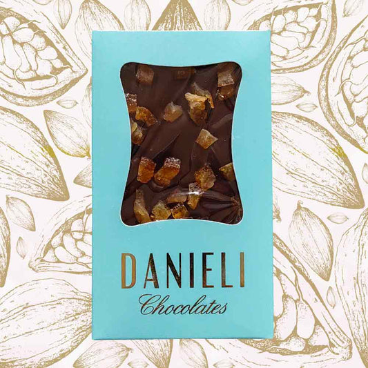 Danieli dark chocolate bar with orange on a cacao pod background