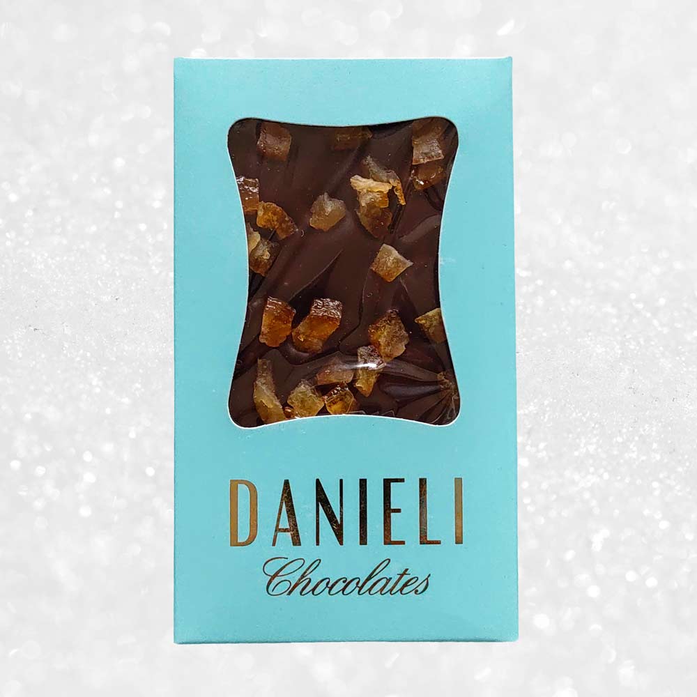 Danieli dark chocolate bar with orange on a snowy background