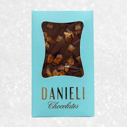 Danieli dark chocolate bar with orange on a snowy background