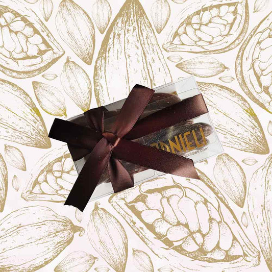 top view of a gift box of Danieli orangettes on a cacao pod background