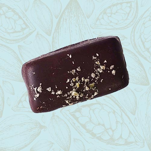 Danieli individual chocolates dark chocolate pistachio marzipan on a blue and brown cacao pod background