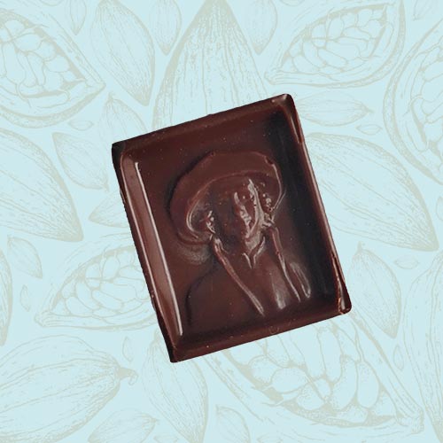 Danieli individual chocolates dark chocolate reubens praline on a blue and brown cacao pod background