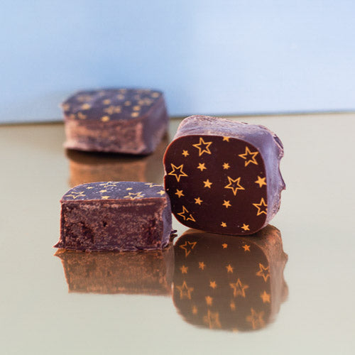 Dark chocolate ganache on a gold background
