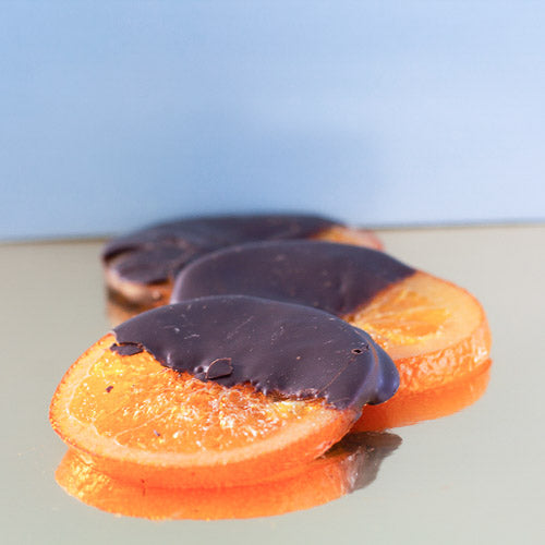 Dark chocolate orange slices on a gold background