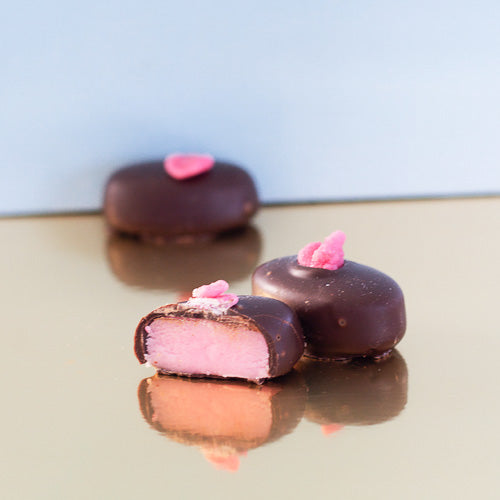 Dark chocolate rose creams on a gold background