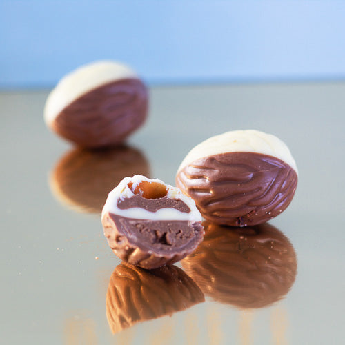 White and milk chocolate praline on a gold background