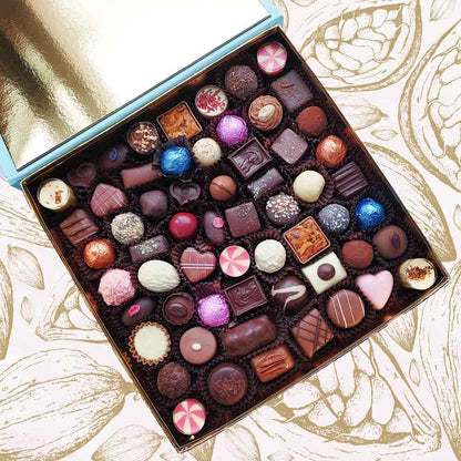inside view of a Danieli chocolate gift box extra large on a cacao pod background