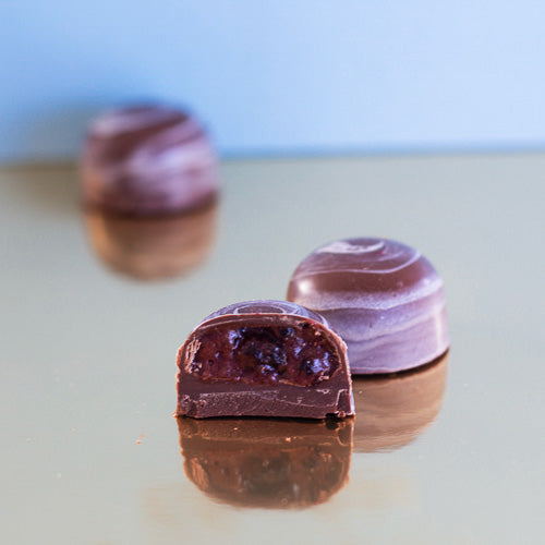 Milk chocolate forest fruits on a gold background
