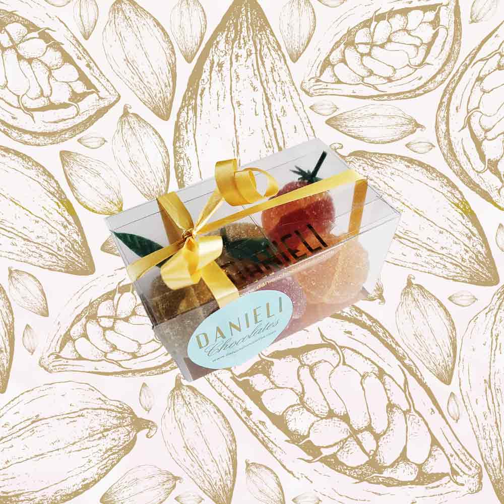 side view of a presentation box of Danieli fruit jellies on a cacao pod background