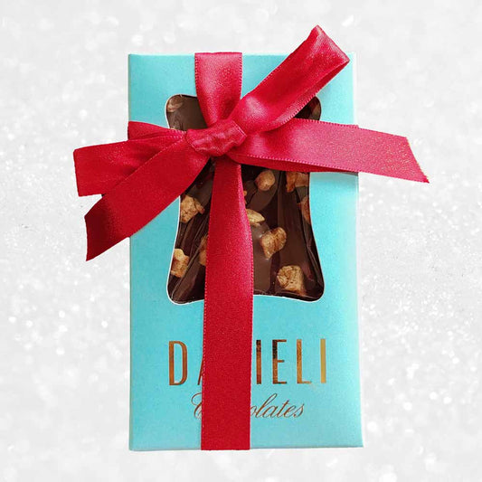 top view of gift pack of three danieli chocolate bars on a snowy background