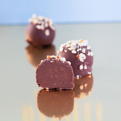 Hazelnut milk chocolate truffle on a gold background