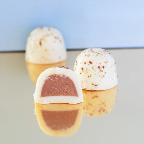 White chocolate praline on a gold background