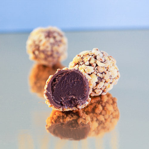 Milk chocolate honeycomb truffle on a gold background