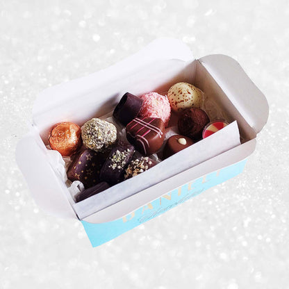 Assorted truffles in a box on a white background