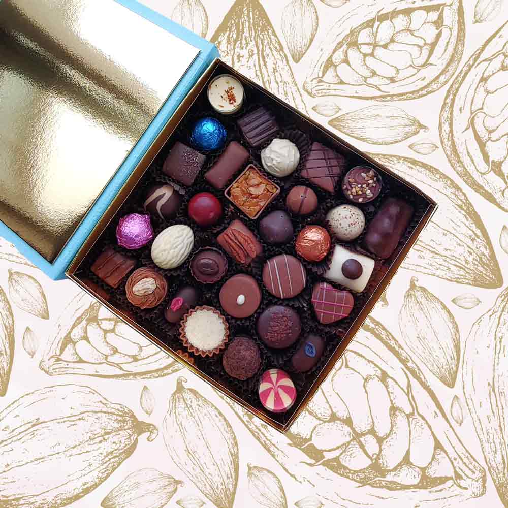 inside view of a Danieli chocolate gift box large with a brown ribbon on a cacao pod background