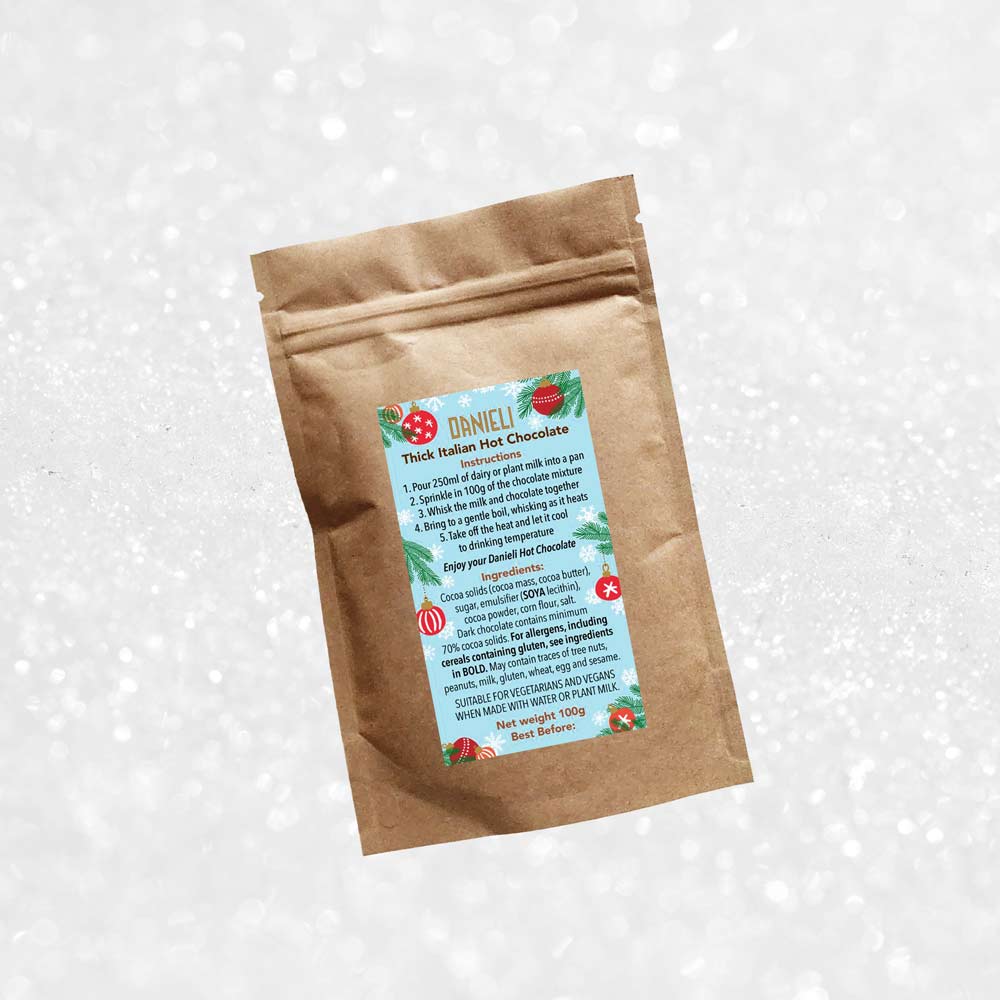 back view of Danieli luxury hot chocolate 100g pouch festive edition on a snowy background