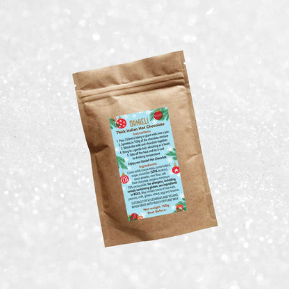 back view of Danieli luxury hot chocolate 100g pouch festive edition on a snowy background