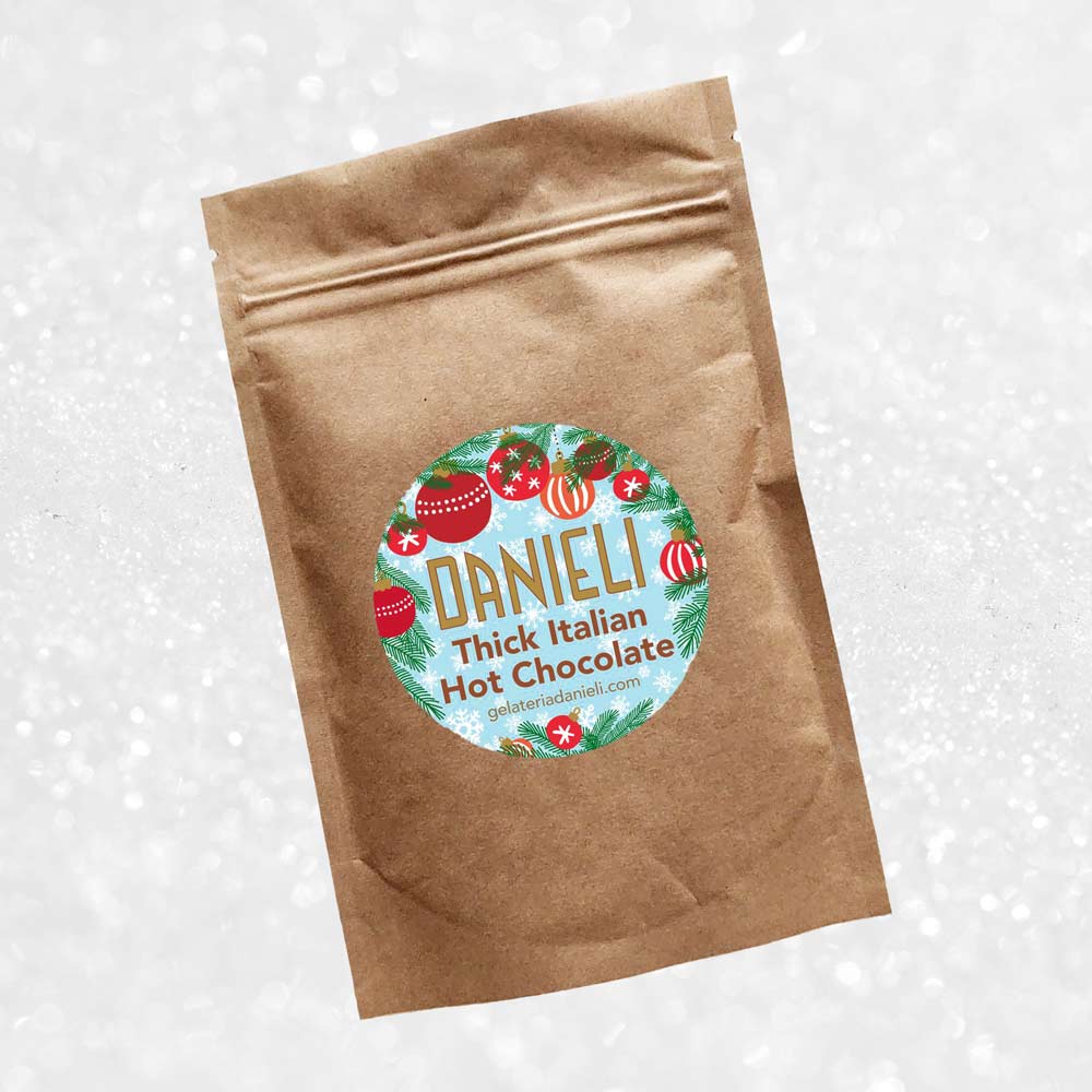 front view of Danieli luxury hot chocolate 300g pouch christmas edition on a snowy background