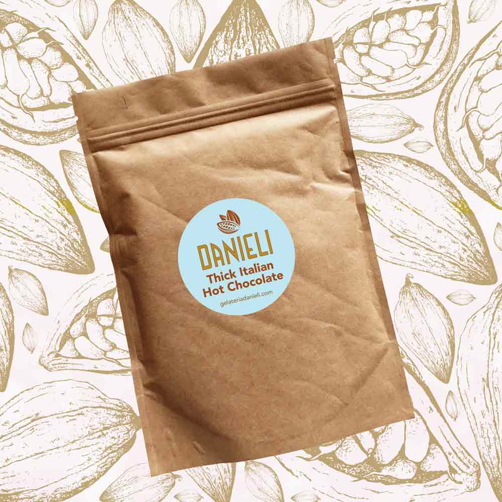 front view of Danieli luxury hot chocolate 300g pouch Classic edition on a cacao background