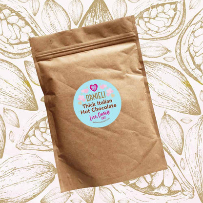 front view of Danieli luxury hot chocolate 300g pouch pink edition on a cacao background