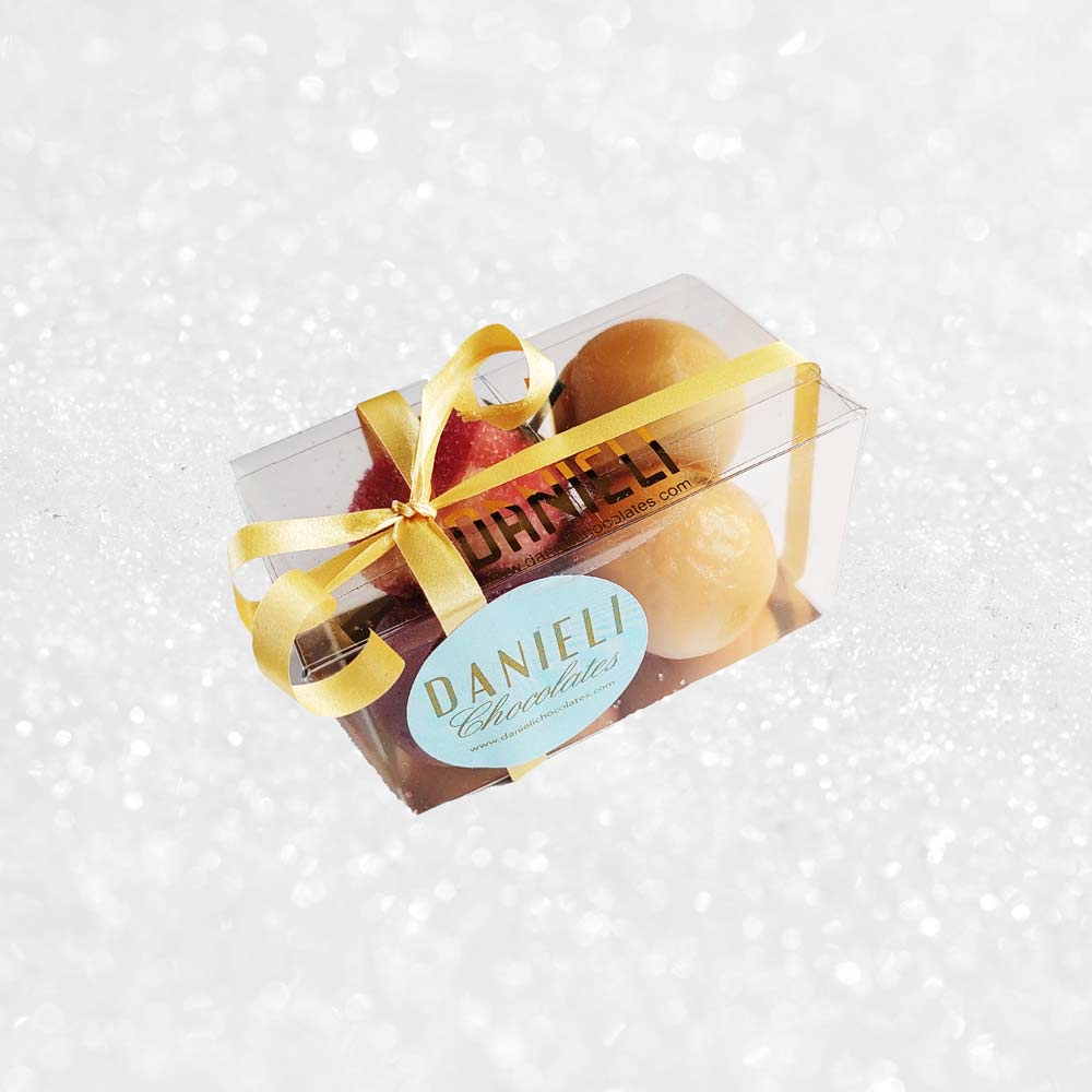top view of a gift box of Danieli marzipan fruits on a snowy background