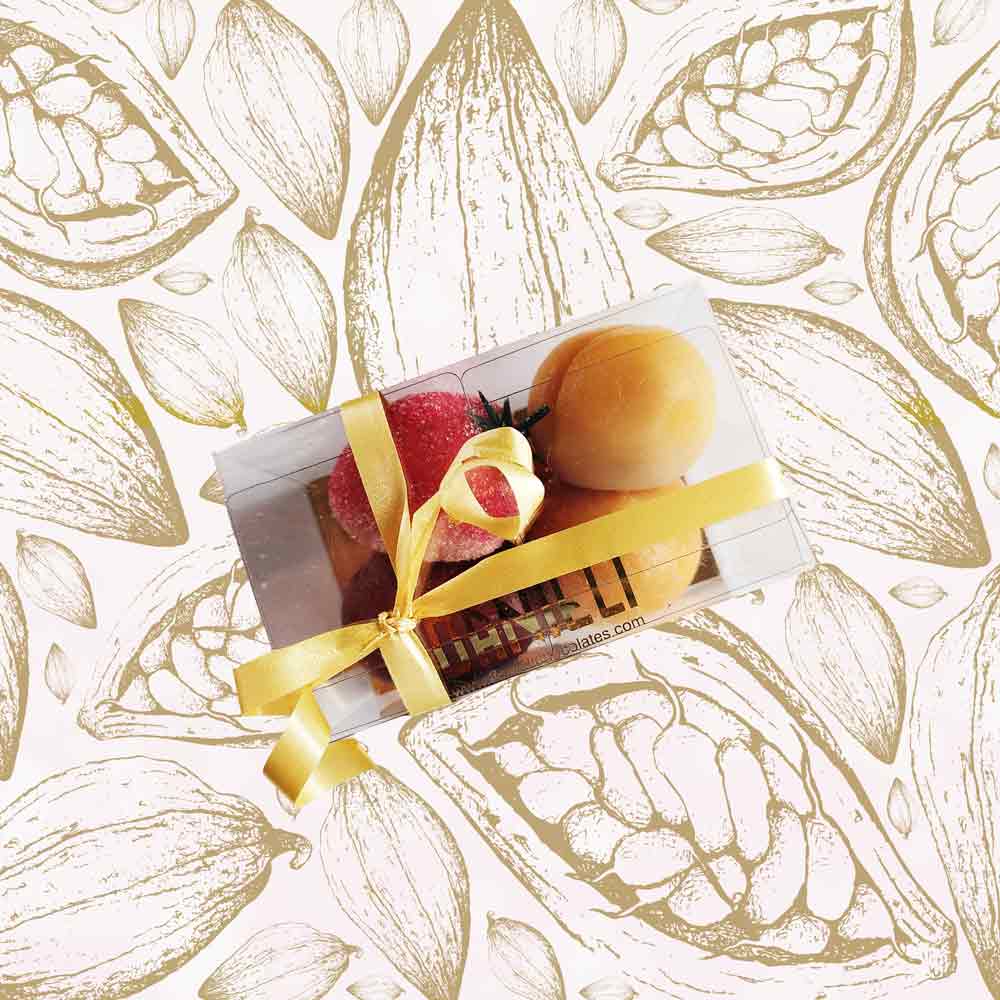 top view of a gift box of Danieli marzipan fruits on a cacao pod background
