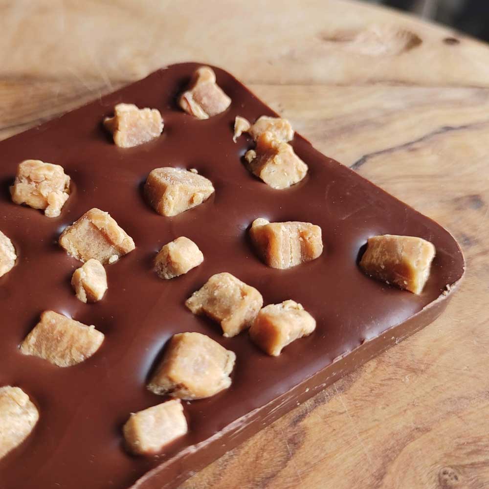 close up of Danieli milk chocolate fudge bar on a wooden board