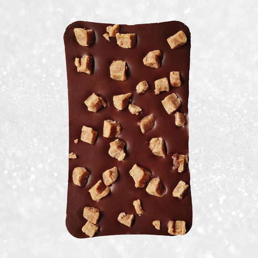 whole bar of danieli milk chocolate fudge bar on a snowy background