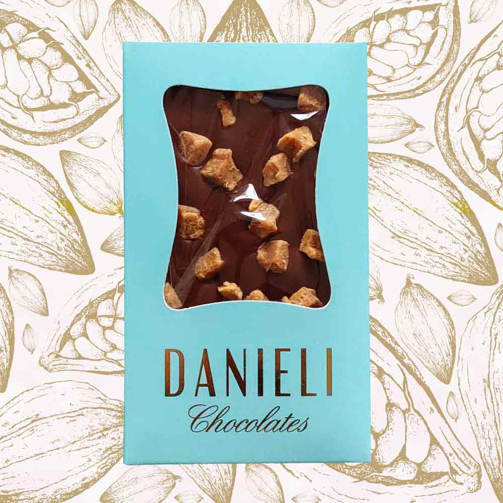 Danieli milk chocolate bar with fudge on a cacao pod background