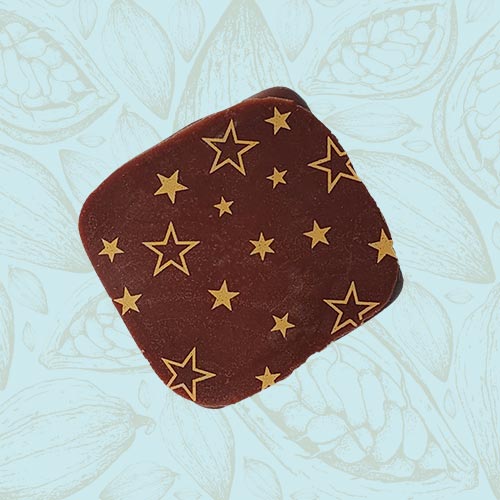 Danieli individual chocolate milk chocolate ganache on a blue and brown cacao pod background