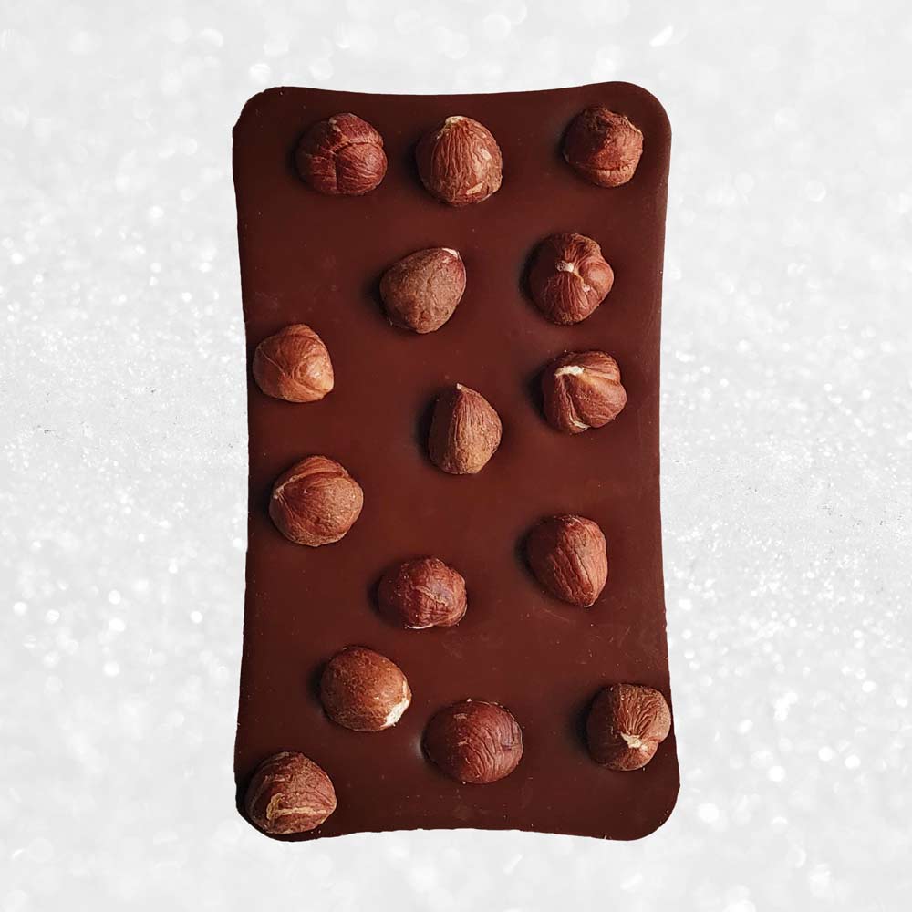 whole bar of danieli handmade milk chocolate hazelnut chocolate bar on a snowy background