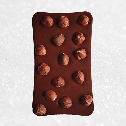 whole bar of danieli handmade milk chocolate hazelnut chocolate bar on a snowy background